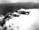 African-American US Army pilots flying P-40 Warhawk fighters over Selfridge Field, Michigan, United States, circa 28 Jun-14 Sep 1943
