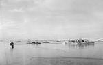HMS Norfolk with other ships of an Arctic Convoy in a Russian inlet, circa 1943
