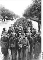 Soviet soldier with PPD submachine gun with a column of German prisoners of war, Berlin, Germany, May 1945