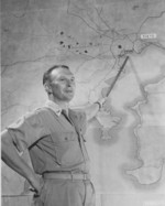 US officer pointing at Tokyo, Japan on an enlarged map during a bomber crews briefing, Saipan, Mariana Islands, late Nov 1944