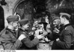 German soldiers and a civilian celebrating with champagne, France, Aug-Sep 1940