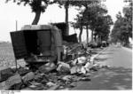 Abandoned vehicles alongside a street in northern France, circa May 1940