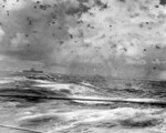 USS Enterprise (left), USS Portland (center), and USS South Dakota (center-right) in action during Battle of the Santa Cruz Islands, 26 Oct 1942; note at least two Japanese aircraft above USS Enterprise, and USS South Dakota firing her secondary battery