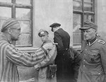 Russian former prisoner liberated by US 3rd Armored Division pointing out former Nazi guard who brutally beat prisoners, possibly at Mittelbau-Dora Concentration Camp, Nordhausen, Germany, 14 May 1945