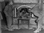 American soldiers inspecting a crematorium stuffed with several bodies, location unknown, Apr 1945
