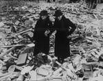 Two women amidst a wrecked building, Newbury, Berkshire, England, United Kingdom, 11 Feb 1943