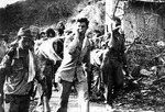 Captured Japanese photograph of Americans POWs carrying the sick and the wounded during the Bataan Death March, Philippine Islands, Apr 1942