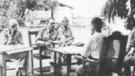 General Edward King (with Everett Williams, Wade Cothran, and Achille C. Tisdelle) negotiating surrender with Japanese officer Nakayama, Balanga Elementary School, Balanga, Bataan, Philippines, 9 Apr 1942