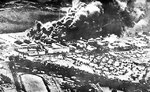 P-40 fighters and hangars burning at Wheeler Field, US Territory of Hawaii, 7 Dec 1941; photo taken from a Japanese aircraft