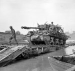 An Achilles 17pdr tank destroyer crossing the River Savio on a Churchill ARK which was driven into the river, Italy, 24 Oct 1944