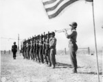 Japanese-American soldiers of 2nd Battalion, US 442nd Regimental Combat Team playing taps after riflemen fired salute, memorial ceremony for the fallen, Cecina area, Italy, 30 Jul 1944