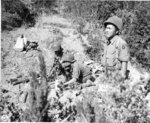 Japanese-American mortar crew of 100th Infantry Battalion, US 442nd Regimental Combat Team firing into suspected German sniper positions, Montenero area, Italy, 7 Aug 1944, photo 1 of 2