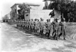 Japanese-American troops of US 442nd Regimental Combat Team marching through Vada, Italy, 1944