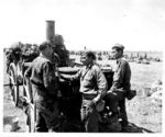 Japanese-American troops of 100th Infantry Battalion, US 442nd Regimental Combat Team inspecting a confiscated German field kitchen, Brescia, Italy, 18 May 1945, photo 1 of 2