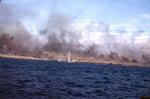 Explosions at the beach edge, with smoke rising from other hits just inland on Iwo Jima, probably during the pre-landing bombardment, 19 Feb 1945