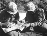Americans Major Richard Fagan and Captain Pierson of 3rd Battalion, 26th Marines studied aerial photos, Iwo Jima, morning of 22 Feb 1945