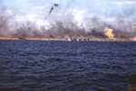 Explosions and yellow signal smoke just offshore and on Iwo Jima, 19 Feb 1945, photo 2 of 2