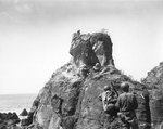 Americans attacked Japanese snipers in a cave with bazooka and small arms, northern coast of Iwo Jima, during mop up operations, 8 Apr 1945