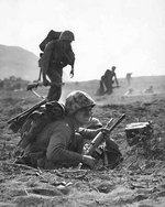 A carbine-equipped US Marine on Iwo Jima, Feb 1945; note M8 grenade launcher attached to the muzzle of the weapon