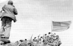 Joe Rosenthal making a photograph of US servicemen with the second flag atop Mount Suribachi, Iwo Jima, Japan, 23 Feb 1945