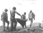 Four American Marines carried a wounded comrade, Iwo Jima, Mar 1945