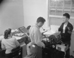 Eunice Yakota, Kiyomi Nakamura, Tsugio Makagama, and Ray Kawamoto working at the office of the newspaper Jerome Communique, Jerome War Relocation Center, Arkansas, United States, 18 Nov 1942