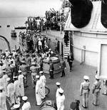Japanese delegation leaving the USS Missouri in Tokyo Bay, Japan after signing the surrender documents, 2 Sep 1945, photo 1 of 2; note the temporary photographers platforms built outboard of the verandah deck