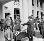 Lieutenant General F. W. Messervy of Malaya Command receiving the sword of General Itagaki of Japanese 7th Area Army at a formal ceremony of surrender, Victoria Institution, Kuala Lumpur, Malaya, 22 Feb 1946
