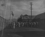 Former captives raising a US flag at Hakodate Branch Camp No. 3, Hokkaido, Japan, 1945