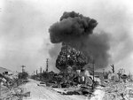 An oil dump exploding at Garapan, Saipan, Mariana Islands, 7 Jul 1944