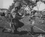 US Marine giving an interned child candy, Tinian, Mariana Islands, 1944