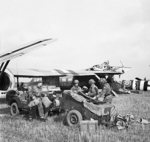 Men of Headquarters Artillery Group of UK 1st Airlanding Reconnaissance Squadron landing near Arnhem, Gelderland, the Netherlands, 17 Sep 1944; note the two collided Horsa gliders in background