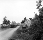 Sherman tanks of the UK Irish Guards Group advancing past Sherman tanks knocked out in previous actions, the Netherlands, 17 Sep 1944