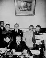 Molotov signing the German-Soviet non-aggression pact, Moscow, Russia, 23 Aug 1939; Shaposhnikov, Ribbentrop, and Stalin in back row
