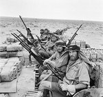 A close-up of a British heavily armed patrol of L Detachment SAS in their jeeps, just back from a three month patrol, 18 Jan 1943; note twin-mounted Vickers K machine guns and F-S dagger; photo 1 of 3