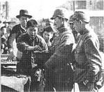 Japanese soldiers purchasing items from Chinese vendors, Nanjing, China, 17 Dec 1937; the Chinese claimed this to be a staged photo for propaganda