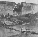 Japanese soldiers crossing a river near the Nanjing city wall, China, 13 Dec 1937