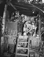 US Army Private First Class George Chapman and Sergeant John Eppard working at the Mobile Machine Shop truck of 741st Ordnance Company, 41th Infantry Division at Horanda, New Guinea, 9 May 1943