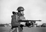 A lance corporal of the British Army East Surrey Regiment posed with a Thompson sub-machinegun, Chatham in Kent, England, United Kingdom, 25 Nov 1940