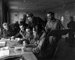 RAF and US Navy VCS-7 pilots briefed before flying a gunfire spotting mission over the Normandy beach heads, circa Jun-Jul 1944