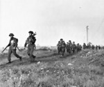 Troops of the Canadian Royal Winnipeg Rifles regiment marching in Normandy, France, 6 Jun 1944