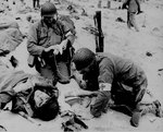 Medics helping injured soldier, France, 1944