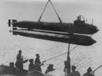 A German one-man submarine preparing to be launched into the River Seine near the Normandy invasion beaches in France, 24 Jul 1944; note torpedo fitted underneath the craft