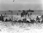 German prisoners of war in a barbed-wire enclosure on Utah Beach, Normandy, 6 Jun 1944; note M4 Sherman tank 