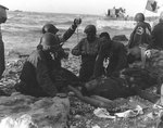 US Army medics administered a plasma transfusion to an injured soldier, Fox Green Sector, Omaha Beach, Normandy, 12 Jun 1944