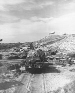 US Army vehicles moved inland from a Normandy invasion beach, Jun 1944