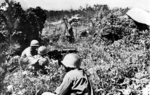 Browning M1917A1 machine gun crew of US 96th Division on the top of Yaeju-Dake Hill, Okinawa, Japan, 18 Jun 1945; note yellow cloth front lines marker on right