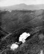 US Marine F4U Corsair fighter dropping a fire bomb on a Japanese position in Northern Okinawa, Japan, circa Apr-Jun 1945