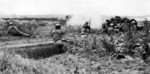 Men of the 383nd Infantry Regiment, US 96th Division firing at a Japanese position in the Mashiki area, Okinawa, Japan, circa Apr 1945