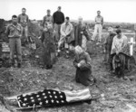 US Marine Colonel Francis Fenton conducting the funeral of his son Private First Class Mike Fenton, near Shuri, Okinawa, Japan, May 1945